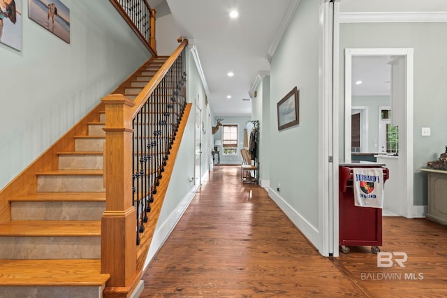 interior space with dark hardwood / wood-style flooring and crown molding