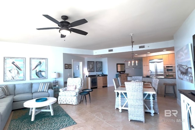 dining room with light tile patterned floors, ceiling fan, wine cooler, and visible vents