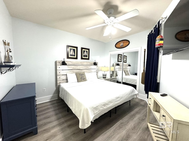 bedroom featuring a ceiling fan, baseboards, and dark wood-type flooring