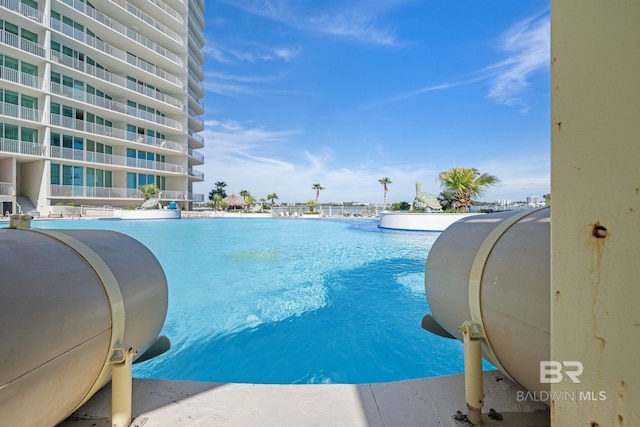 view of swimming pool featuring heating fuel