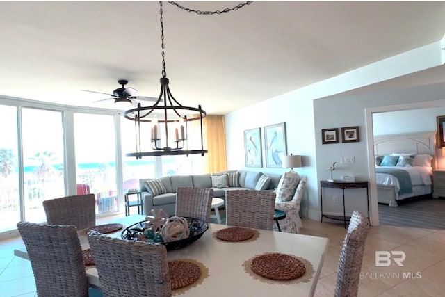 dining space featuring floor to ceiling windows, an inviting chandelier, and light tile patterned floors