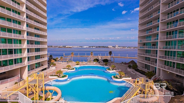 view of swimming pool featuring a water view