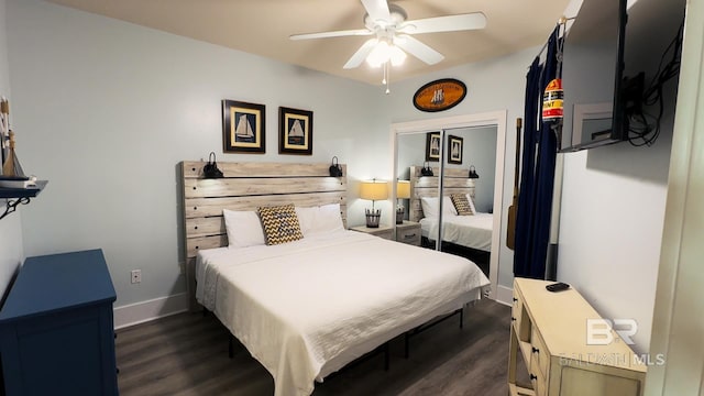 bedroom with a ceiling fan, dark wood-style flooring, and baseboards