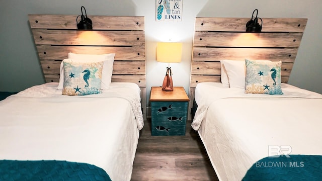 bedroom with dark wood-style floors