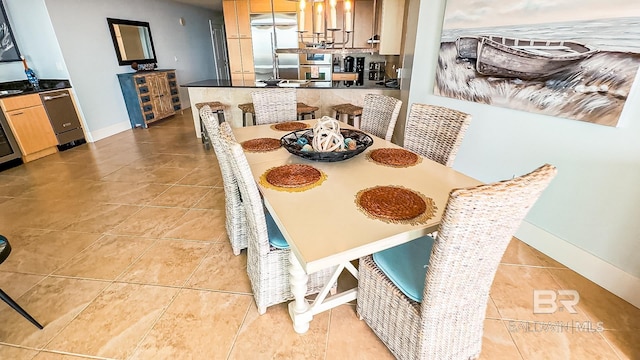 dining space with light tile patterned flooring and baseboards