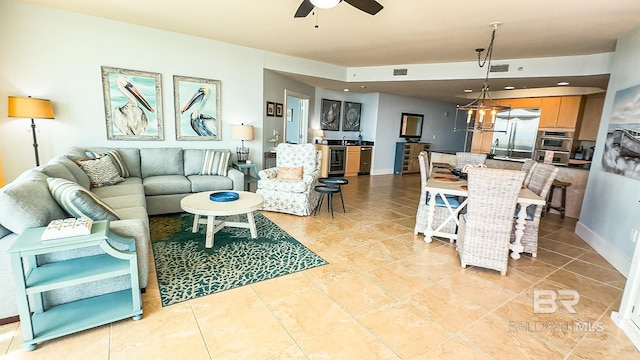 living area featuring ceiling fan, visible vents, and light tile patterned flooring