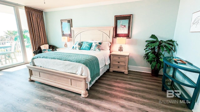 bedroom featuring access to exterior, dark wood-style flooring, ornamental molding, and baseboards