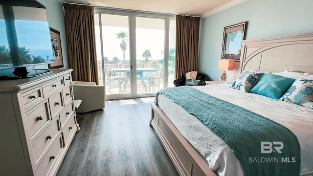 bedroom with expansive windows, ornamental molding, dark wood finished floors, and access to exterior