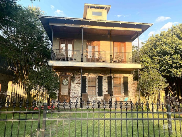 375 S Section St, Fairhope, AL 36532 - front facade featuring brick siding, a balcony, and fence