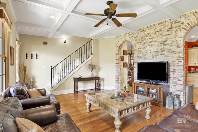 375 S Section St, Fairhope, AL 36532 - living area with a ceiling fan, light wood-style floors, arched walkways, coffered ceiling, and beam ceiling