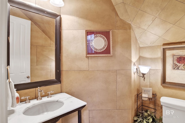 375 S Section St, Fairhope, AL 36532 - bathroom with vanity, tile walls, and toilet