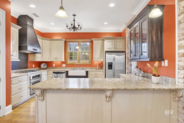 375 S Section St, Fairhope, AL 36532 - kitchen featuring stainless steel appliances, visible vents, premium range hood, crown molding, and a peninsula