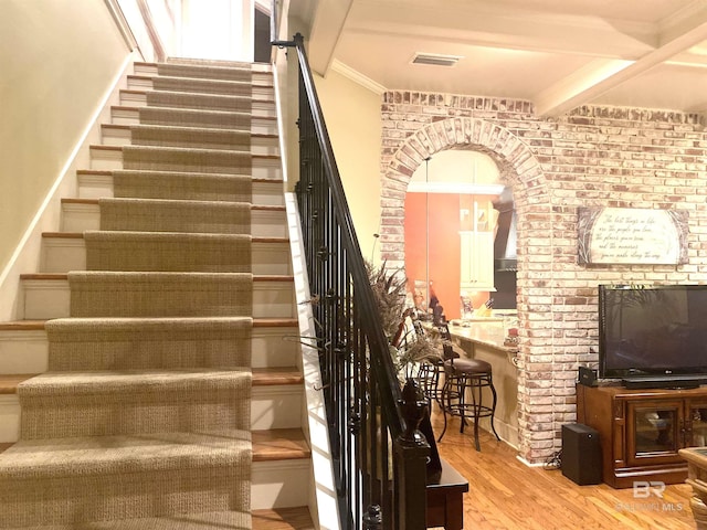 375 S Section St, Fairhope, AL 36532 - staircase with ornamental molding, visible vents, beamed ceiling, arched walkways, and wood finished floors