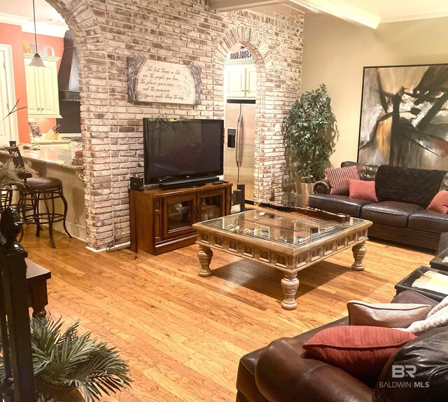 375 S Section St, Fairhope, AL 36532 - living area featuring ornamental molding, light wood-style flooring, arched walkways, and brick wall