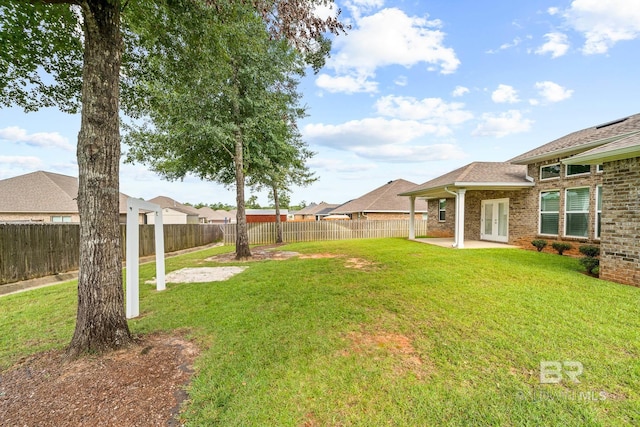 view of yard featuring french doors and a patio