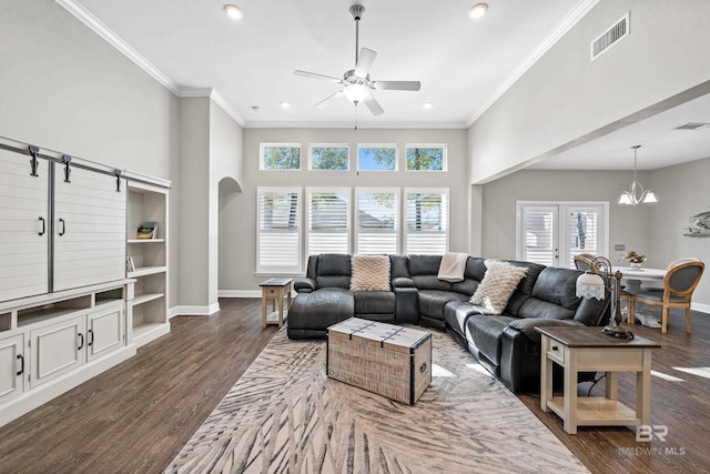 living room with ceiling fan with notable chandelier, french doors, dark hardwood / wood-style flooring, and ornamental molding