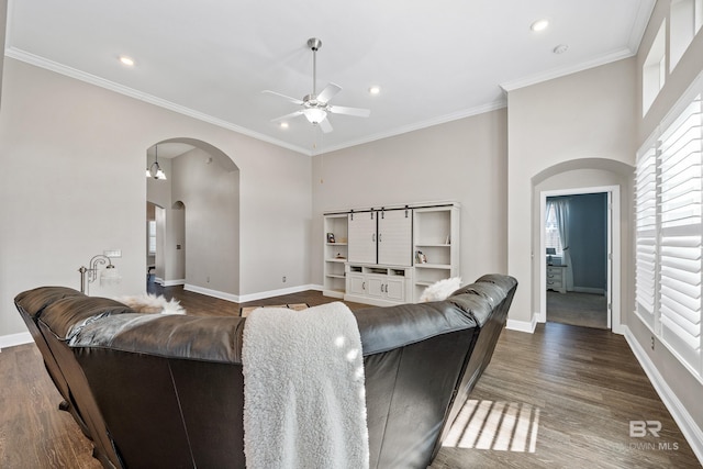 living room with ceiling fan, dark hardwood / wood-style flooring, and crown molding