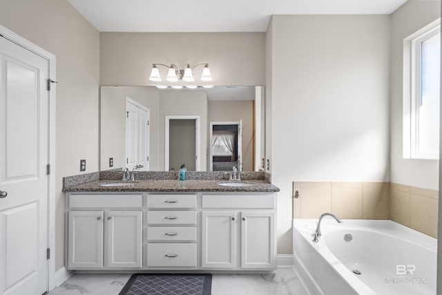 bathroom featuring vanity and a tub to relax in