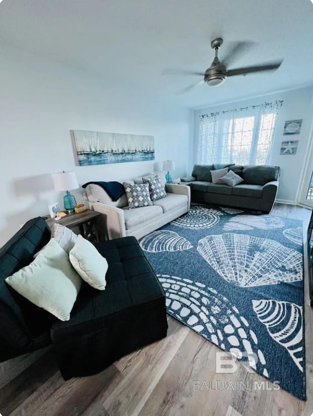 living room with ceiling fan and hardwood / wood-style floors