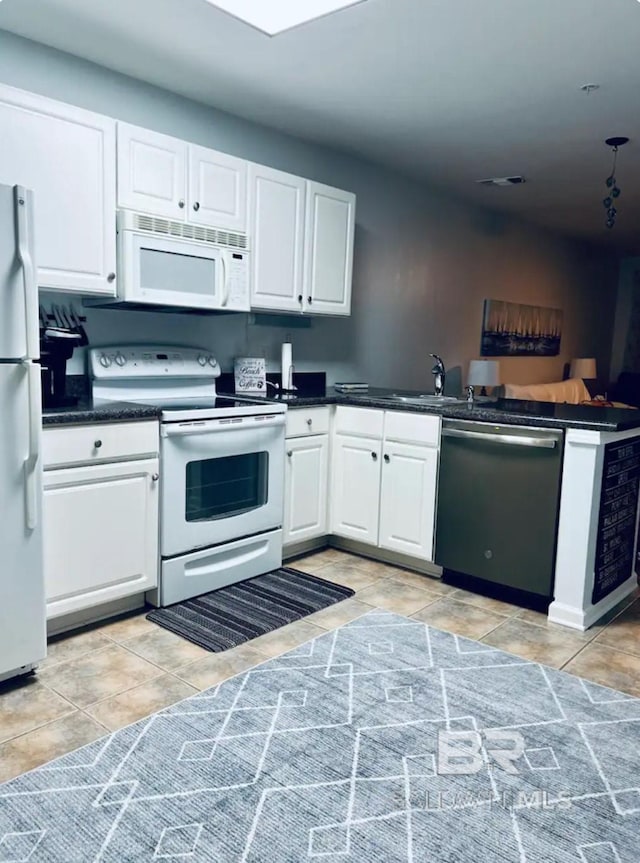 kitchen with sink, white appliances, white cabinetry, and light tile patterned flooring