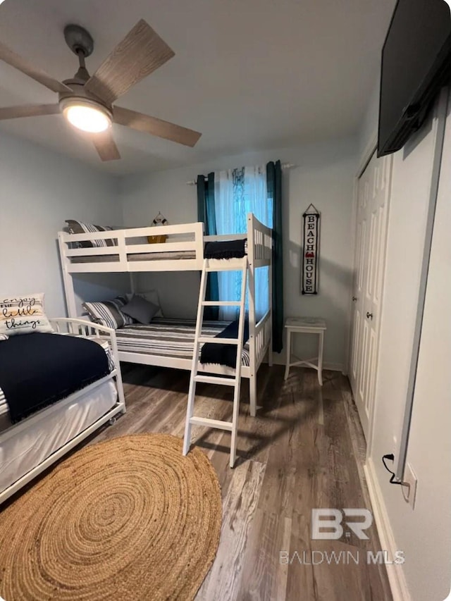 bedroom featuring a closet, ceiling fan, and dark hardwood / wood-style floors