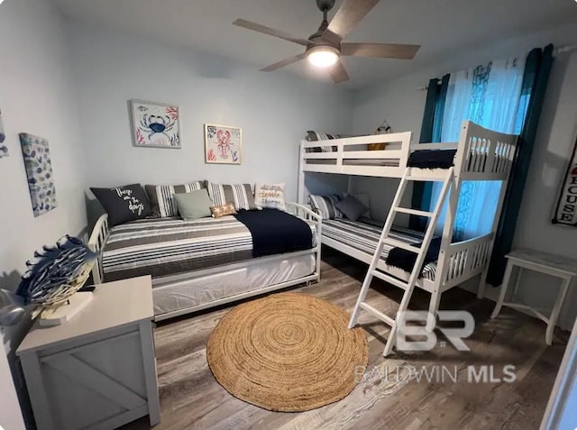 bedroom with ceiling fan and hardwood / wood-style flooring