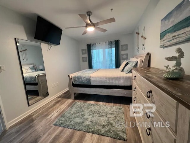 bedroom with ceiling fan and dark wood-type flooring