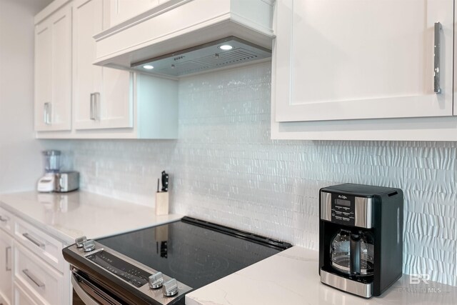 3238 Sea Horse Cir, Gulf Shores, AL 36542 - kitchen featuring white cabinets, stainless steel range with electric cooktop, light stone countertops, backsplash, and custom exhaust hood