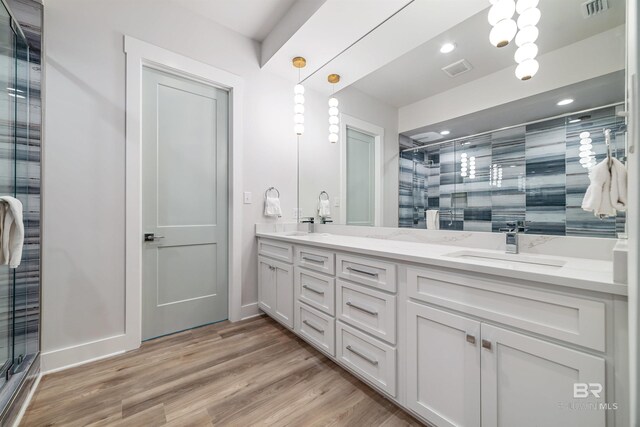 3238 Sea Horse Cir, Gulf Shores, AL 36542 - full bathroom featuring a sink, double vanity, wood finished floors, visible vents, and a stall shower
