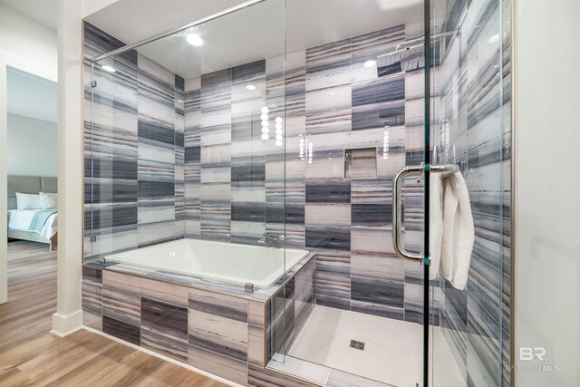 3238 Sea Horse Cir, Gulf Shores, AL 36542 - full bathroom with wood finished floors, a sauna, a bath, a shower stall, and ensuite bath