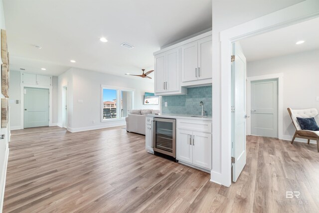 3238 Sea Horse Cir, Gulf Shores, AL 36542 - kitchen featuring visible vents, beverage cooler, open floor plan, a sink, and light wood-style flooring