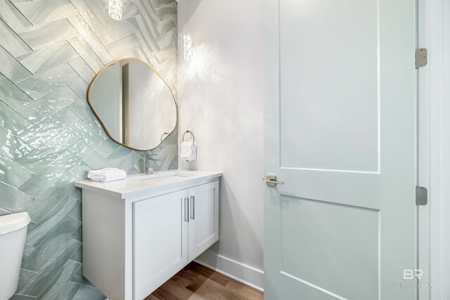 3238 Sea Horse Cir, Gulf Shores, AL 36542 - bathroom featuring vanity, baseboards, toilet, and wood finished floors