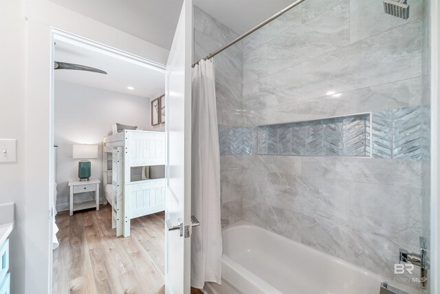 3238 Sea Horse Cir, Gulf Shores, AL 36542 - bathroom featuring vanity, shower / bathtub combination with curtain, wood finished floors, ensuite bathroom, and visible vents