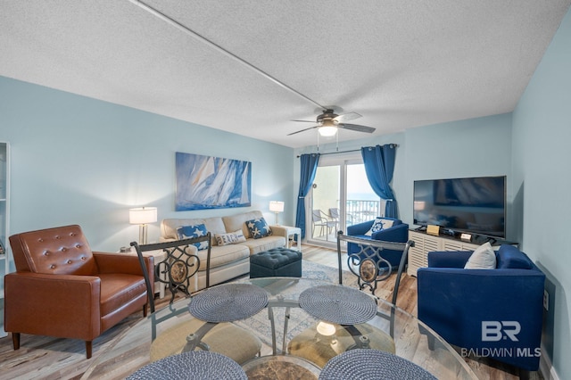 517 E Beach Blvd Unit 1B, Gulf Shores, AL 36542 - living area with light wood-type flooring, a ceiling fan, and a textured ceiling