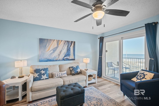 517 E Beach Blvd Unit 1B, Gulf Shores, AL 36542 - living area featuring wood finished floors, a ceiling fan, and a textured ceiling