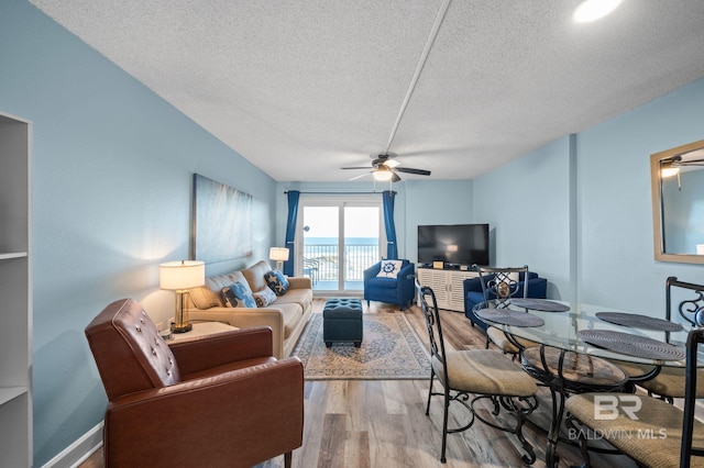 517 E Beach Blvd Unit 1B, Gulf Shores, AL 36542 - living room featuring ceiling fan, a textured ceiling, and wood finished floors
