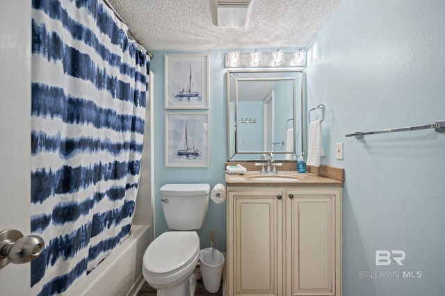 517 E Beach Blvd Unit 1B, Gulf Shores, AL 36542 - bathroom with a textured ceiling, vanity, shower / tub combo with curtain, and toilet