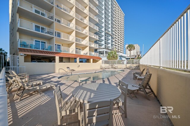 517 E Beach Blvd Unit 1B, Gulf Shores, AL 36542 - view of patio featuring a community pool