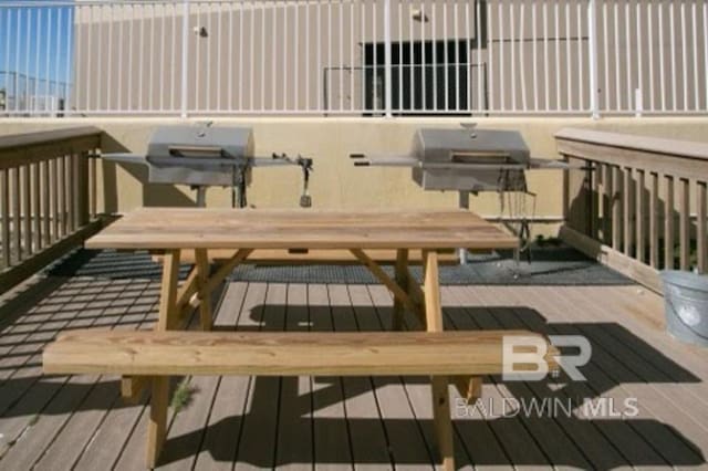517 E Beach Blvd Unit 1B, Gulf Shores, AL 36542 - wooden terrace with a grill