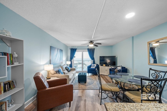 517 E Beach Blvd Unit 1B, Gulf Shores, AL 36542 - living room featuring a ceiling fan, a textured ceiling, wood finished floors, and baseboards