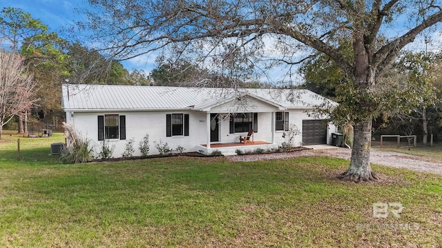 single story home with central AC, covered porch, a front yard, and a garage