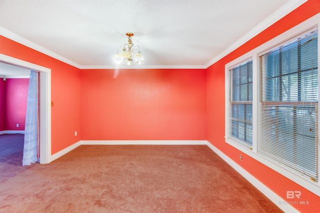 carpeted spare room with ornamental molding and a chandelier