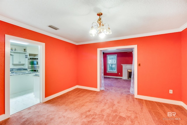 carpeted empty room featuring a textured ceiling, a notable chandelier, and ornamental molding