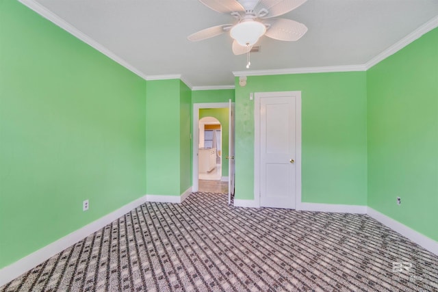 unfurnished bedroom with crown molding, carpet, and ceiling fan