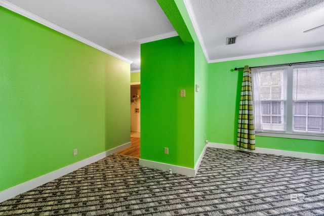 carpeted empty room featuring crown molding and a textured ceiling