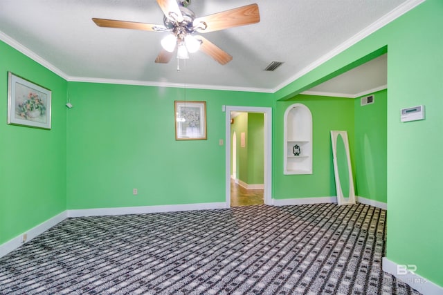 empty room with ceiling fan, ornamental molding, carpet, and a textured ceiling