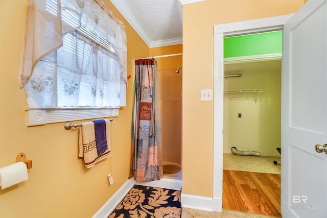 bathroom with walk in shower, ornamental molding, and hardwood / wood-style floors