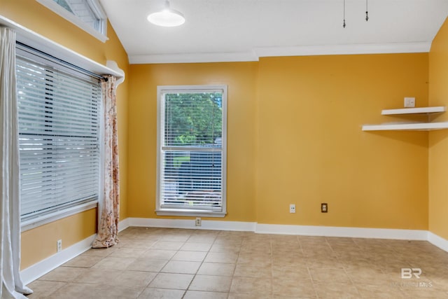 tiled spare room featuring vaulted ceiling and ornamental molding