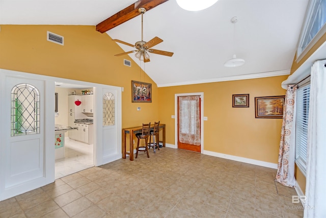 interior space featuring ceiling fan and vaulted ceiling with beams