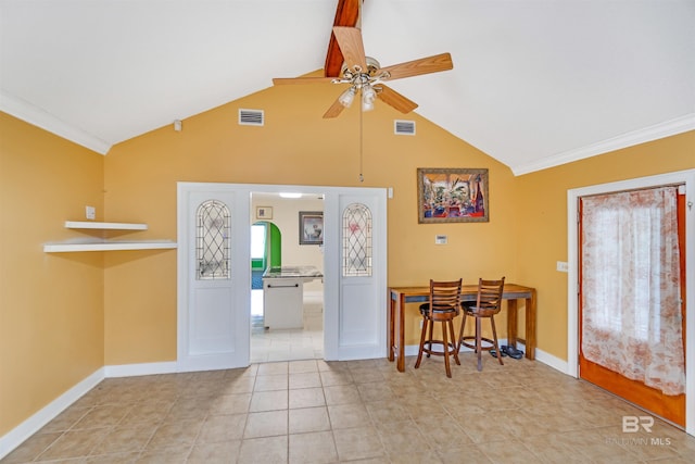 interior space featuring ceiling fan, ornamental molding, light tile patterned floors, and high vaulted ceiling